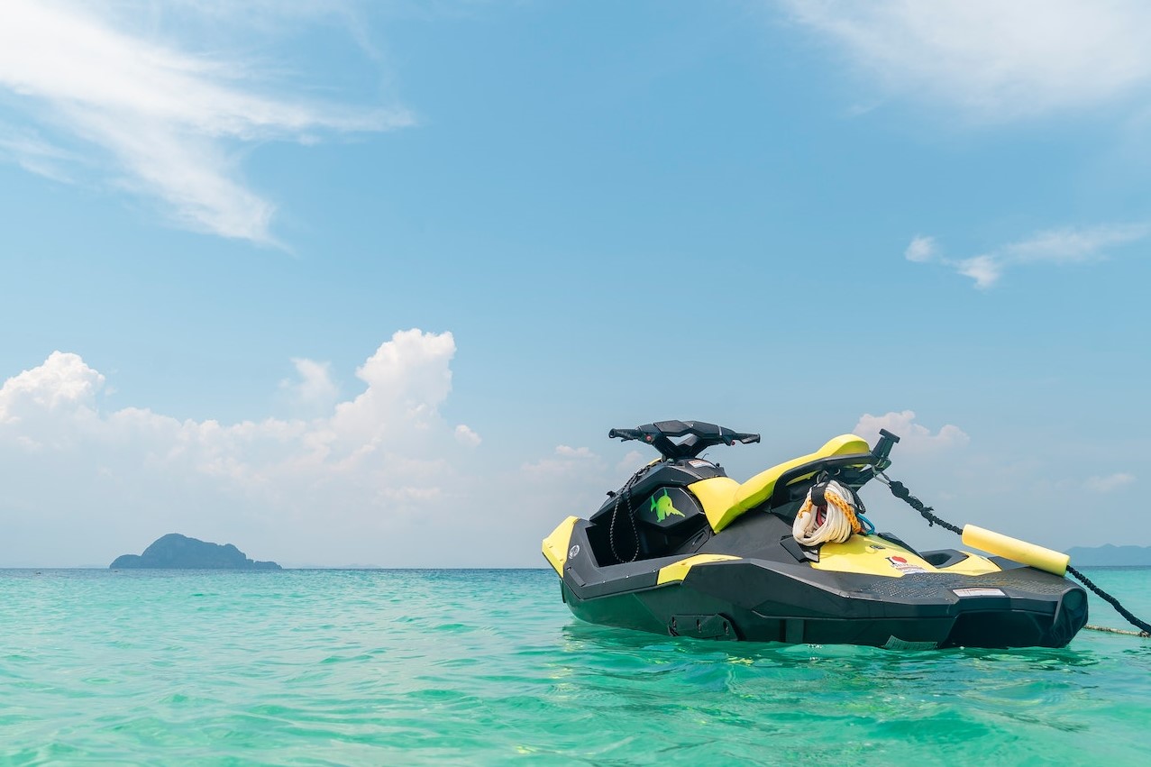 Empty Yellow and Black Jet Ski in Teal Sea Water | Veteran Car Donations