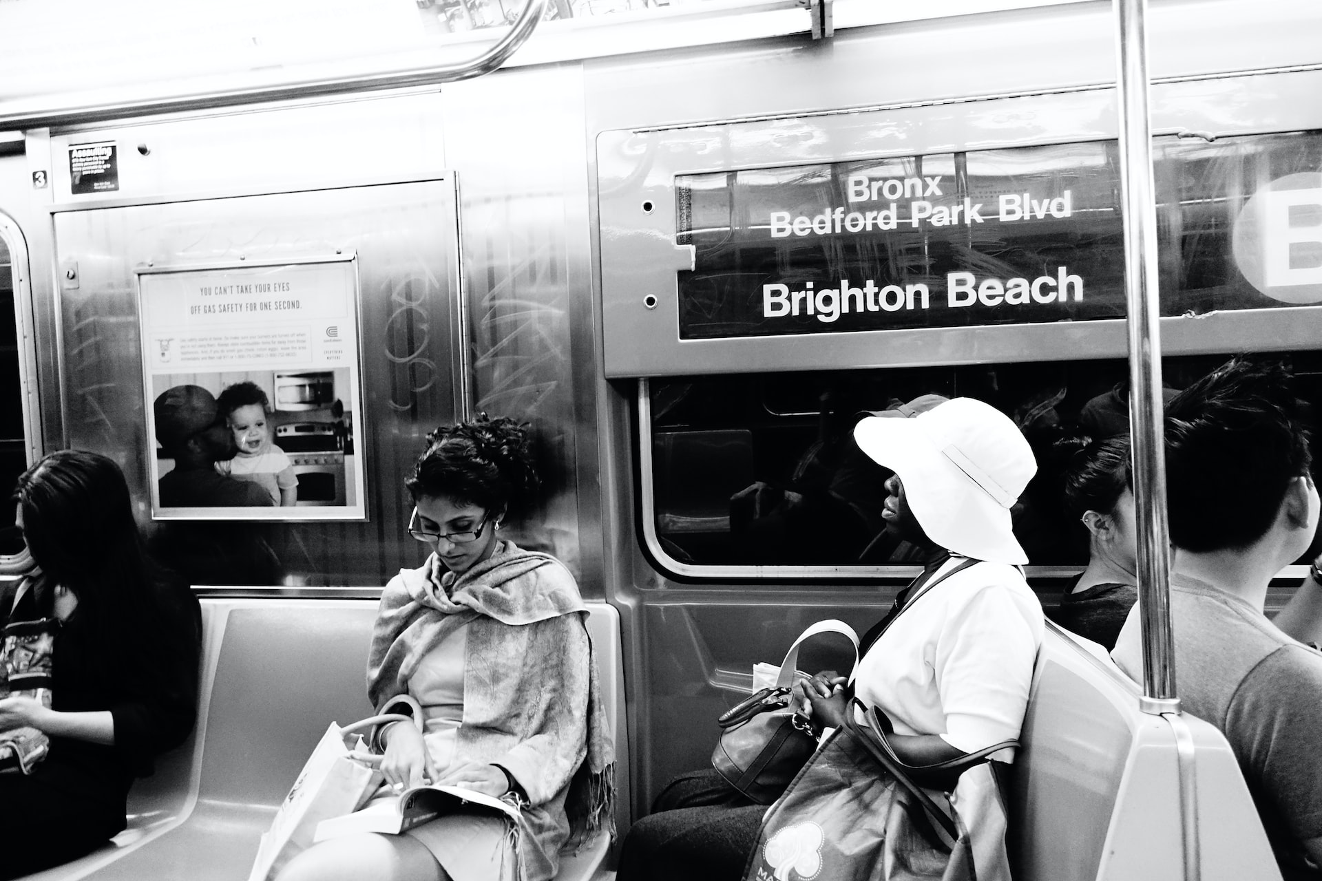 woman in white coat sitting on train seat photo | Veteran Car Donations
