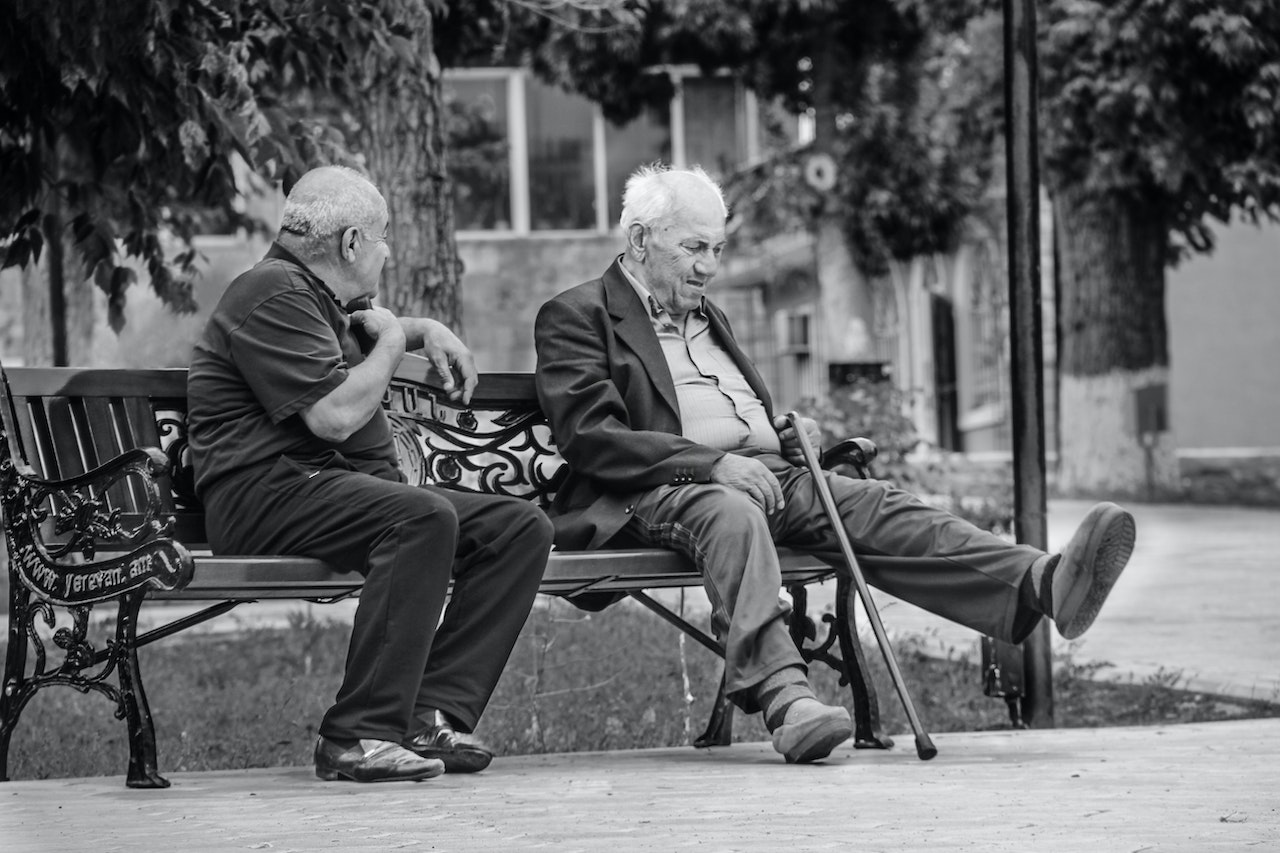 Elderly Men Talking while Sitting on the Bench | Veteran Car Donations
