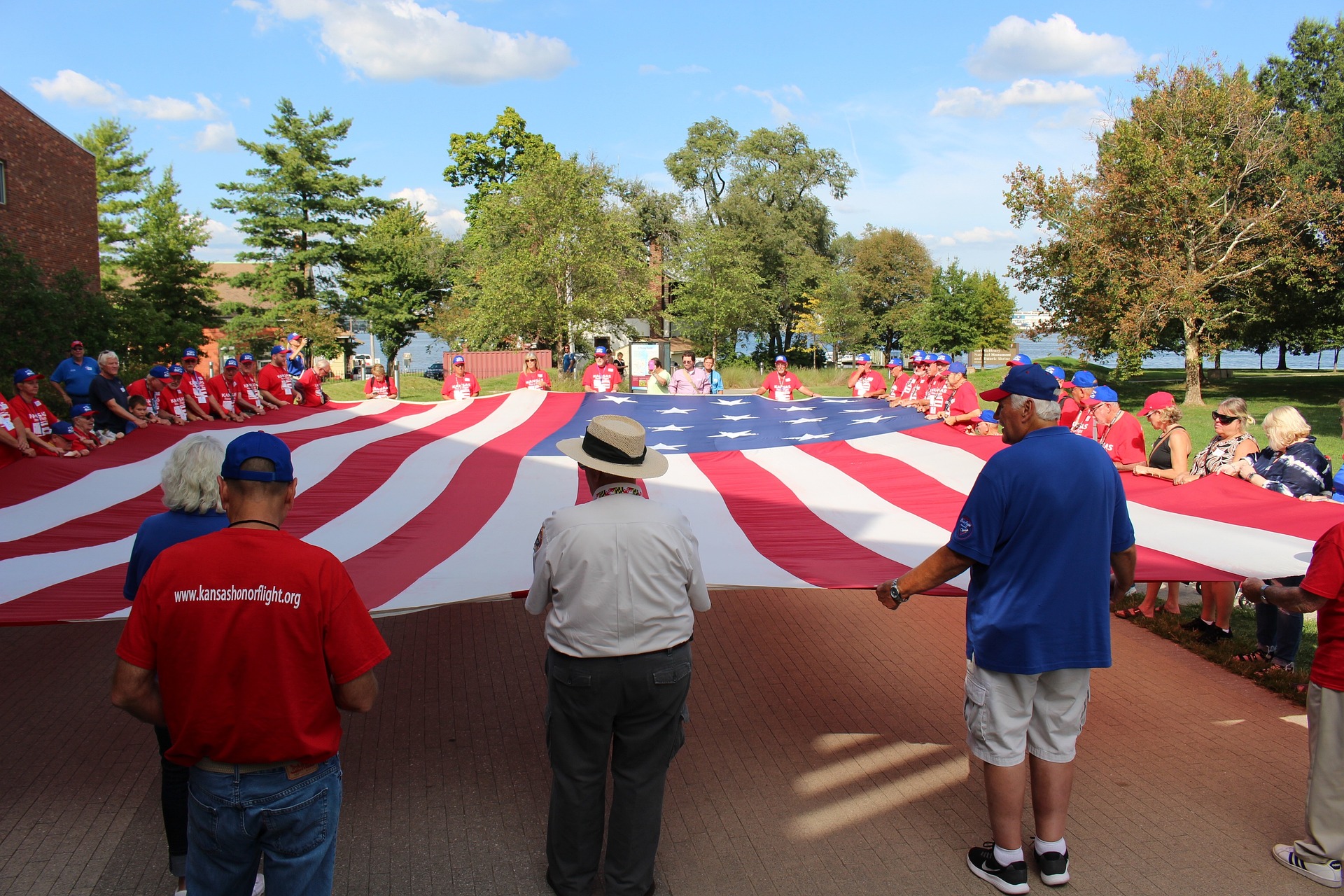 Veterans hold a big flag | Veteran Car Donations