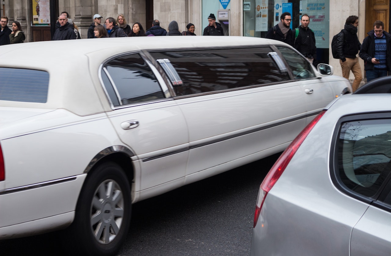 White Limo with people | Veteran Car Donations