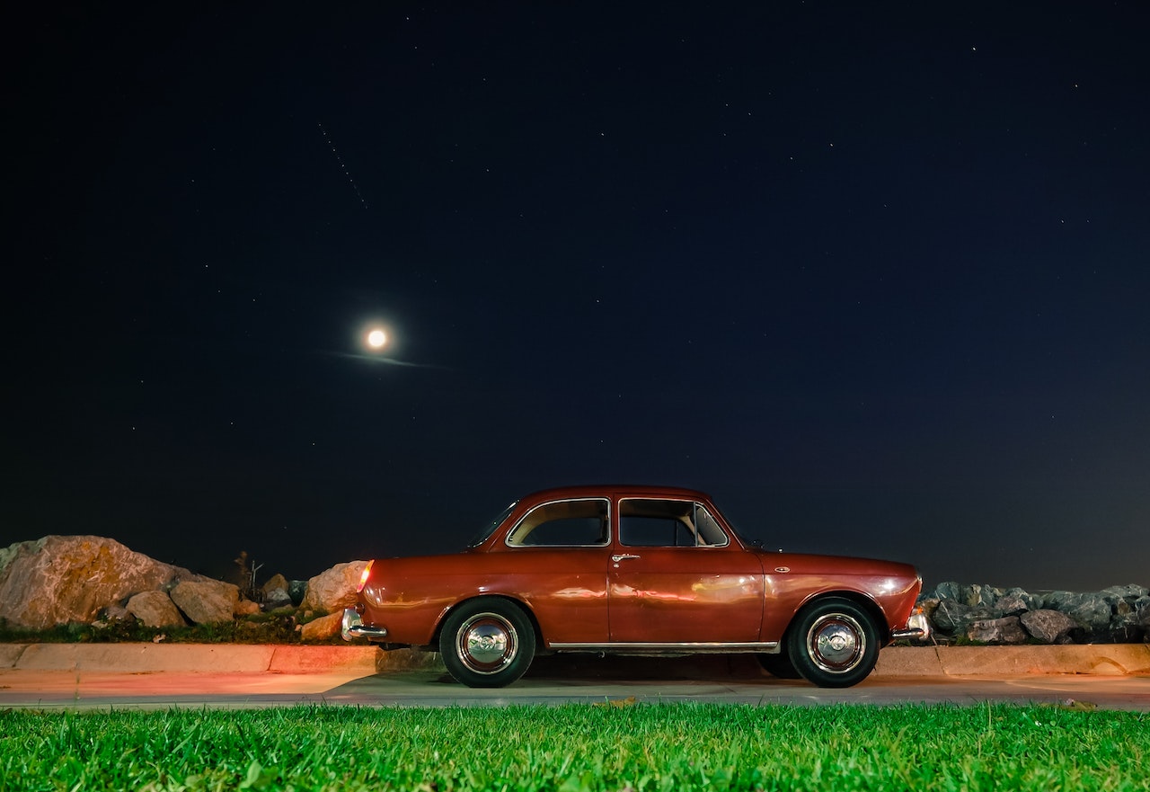 Red coupe under the moon | Veteran Car Donations